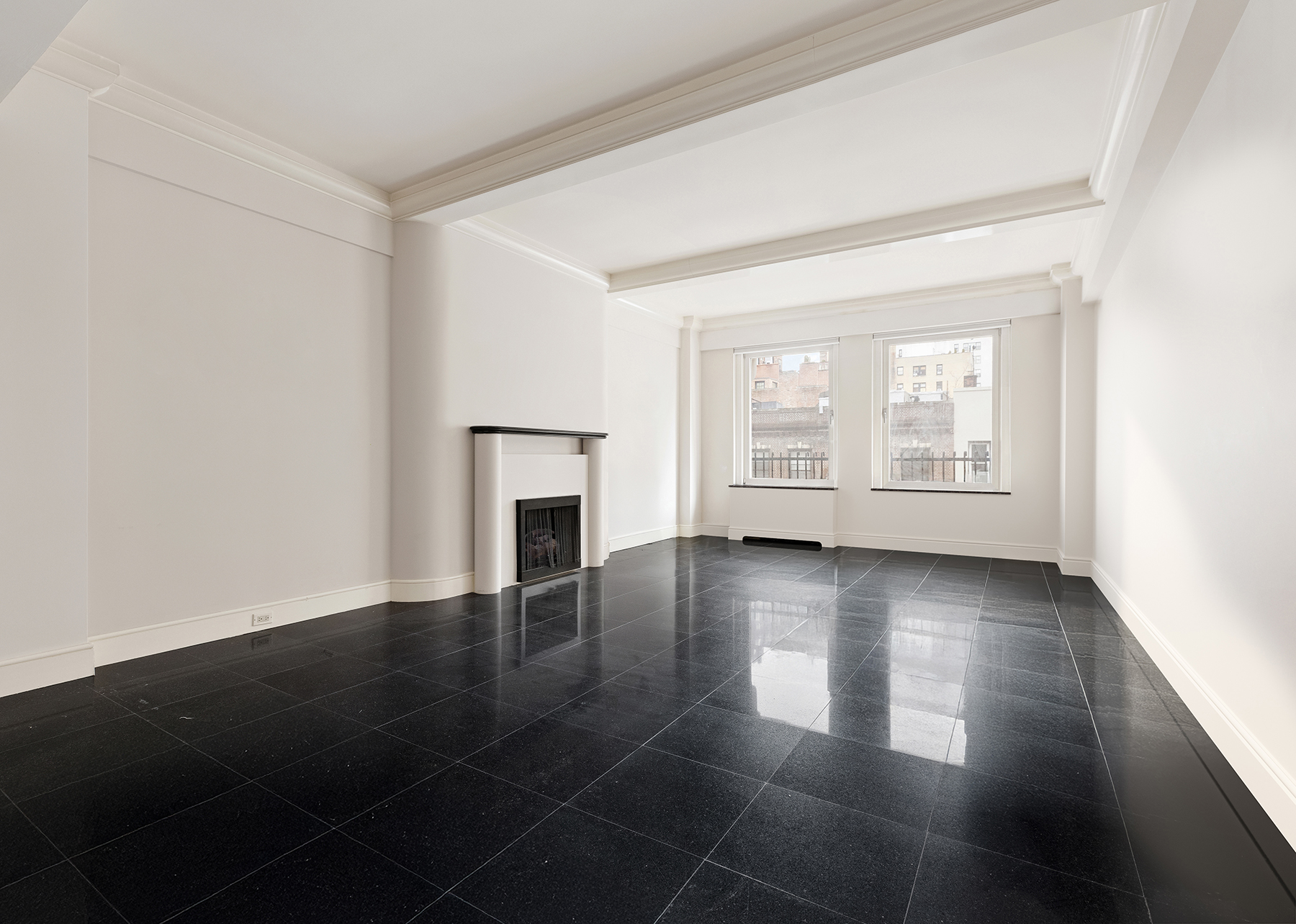 130 East 75th Street, Unit 4D Manhattan, NY 10021 - Photo 2 of 19 an empty room with wooden floor and windows