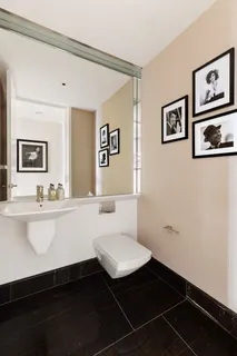 a bathroom with a sink a toilet a mirror and vanity