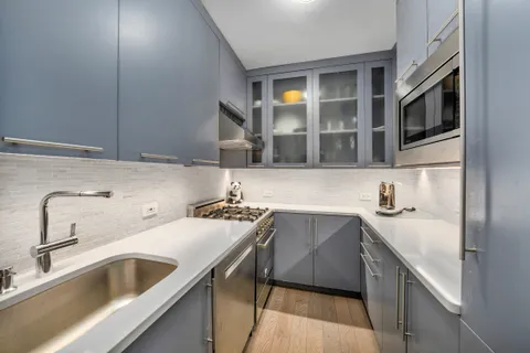 a kitchen with a sink and cabinets