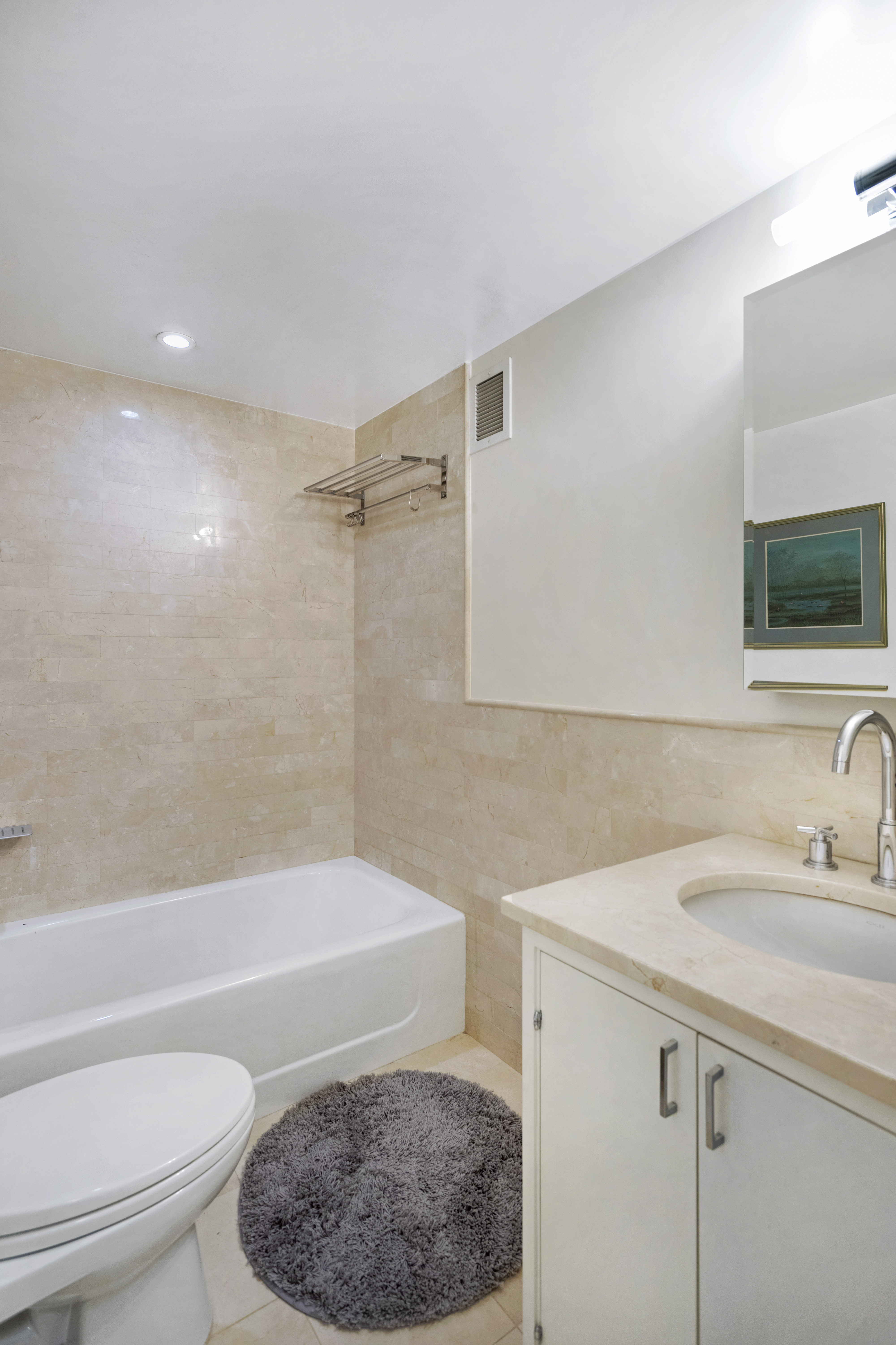 200 East 66th Street, Unit B205 Manhattan, NY 10065 - Photo 11 of 14 a bathroom with a sink toilet and shower