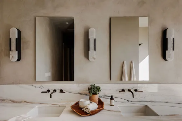 a bathroom with a double vanity sink and mirror