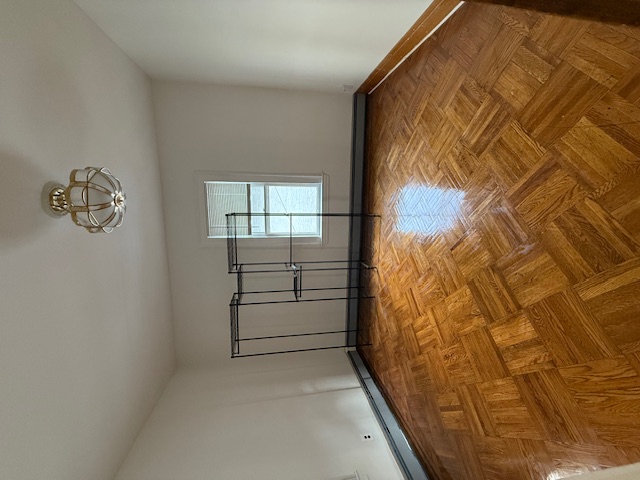 1587 East 18th Street, Unit 2 Brooklyn, NY 11230 - Photo 10 of 13 wooden floor in an empty room with a window