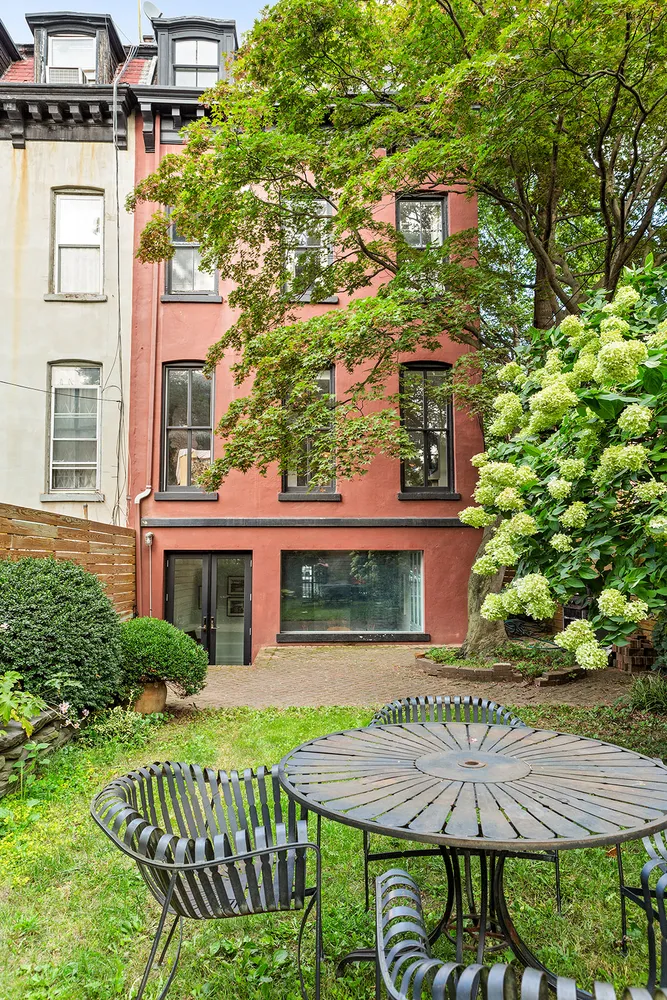 a view of a patio with table and chairs and potted plants