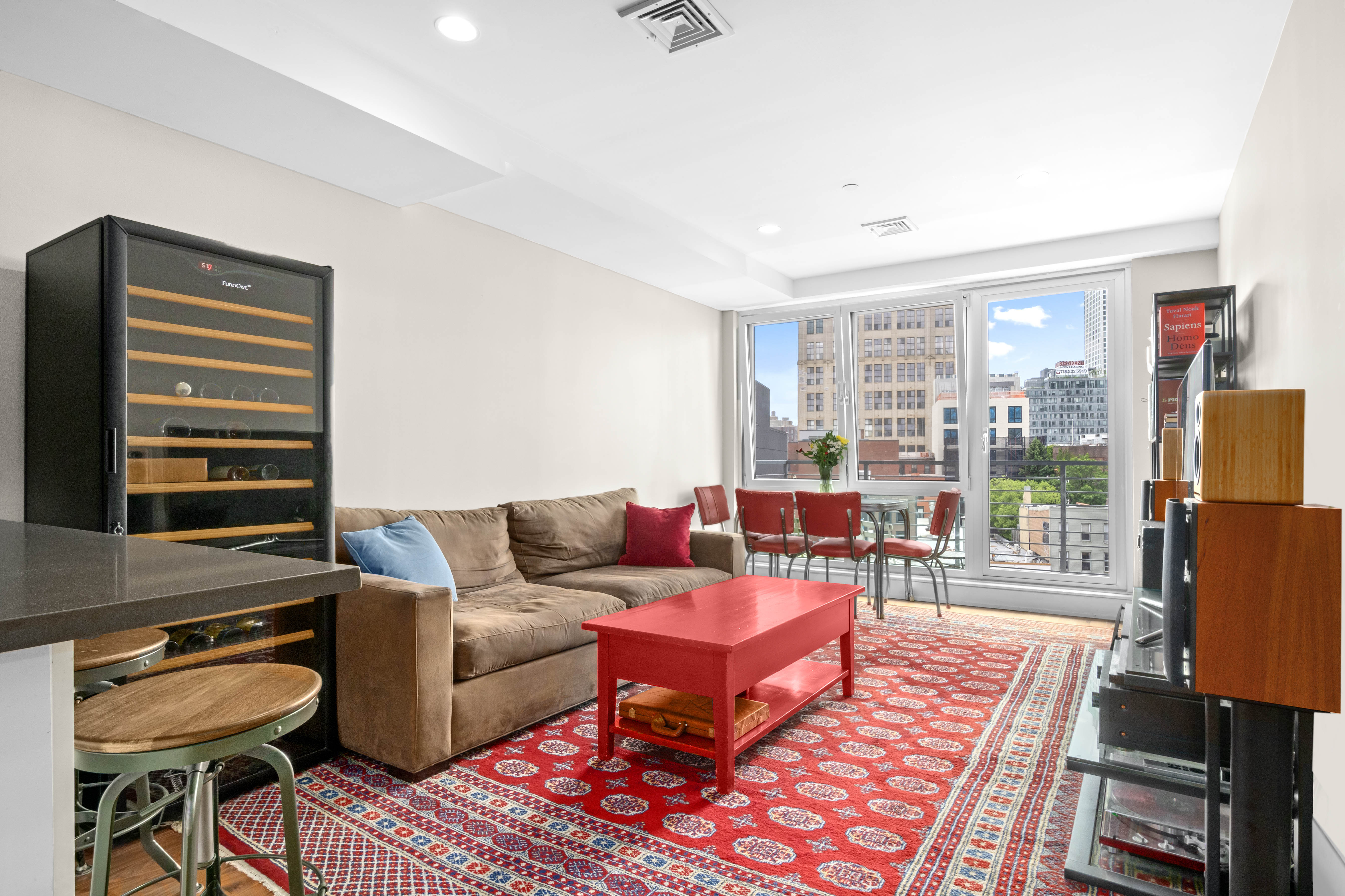 a living room with furniture a flat screen tv and a window