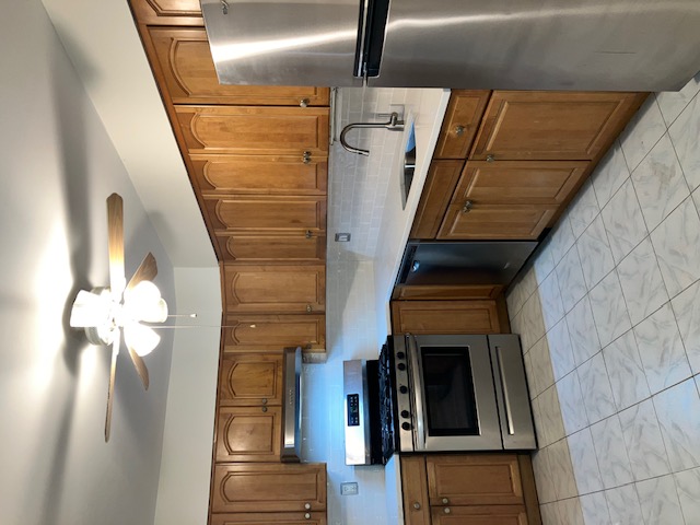 1653 West 9th Street, Unit 2 Brooklyn, NY 11223 - Photo 2 of 7 a kitchen with granite countertop a stove and a sink