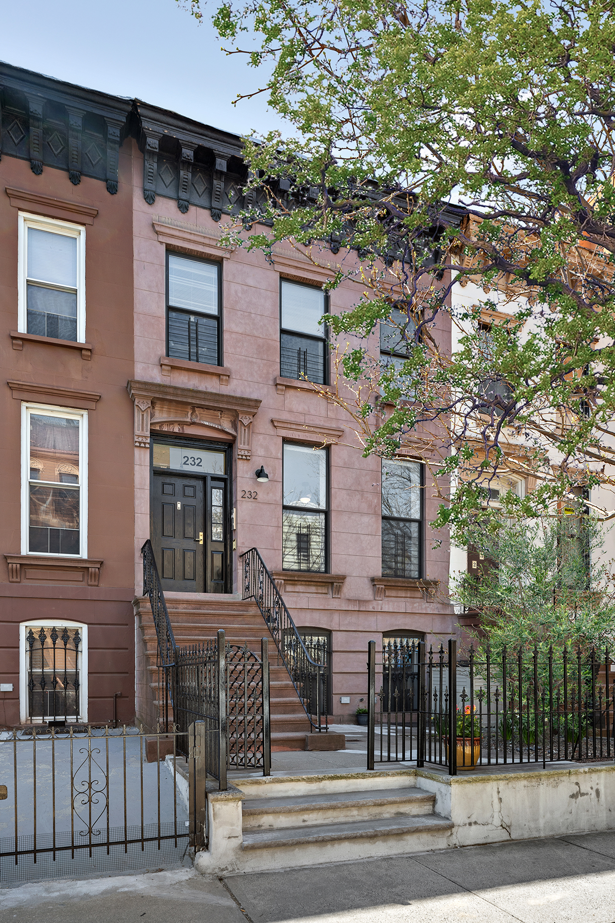 232 Monroe Street Brooklyn, NY 11216 - Photo 20 of 21 a front view of a house with a garden