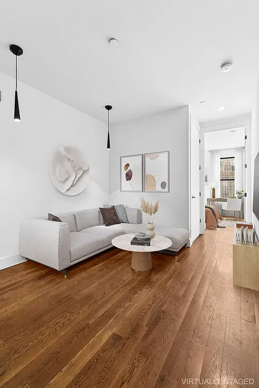 a living room with furniture and wooden floor