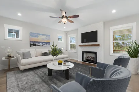 a living room with furniture a fireplace and a flat screen tv