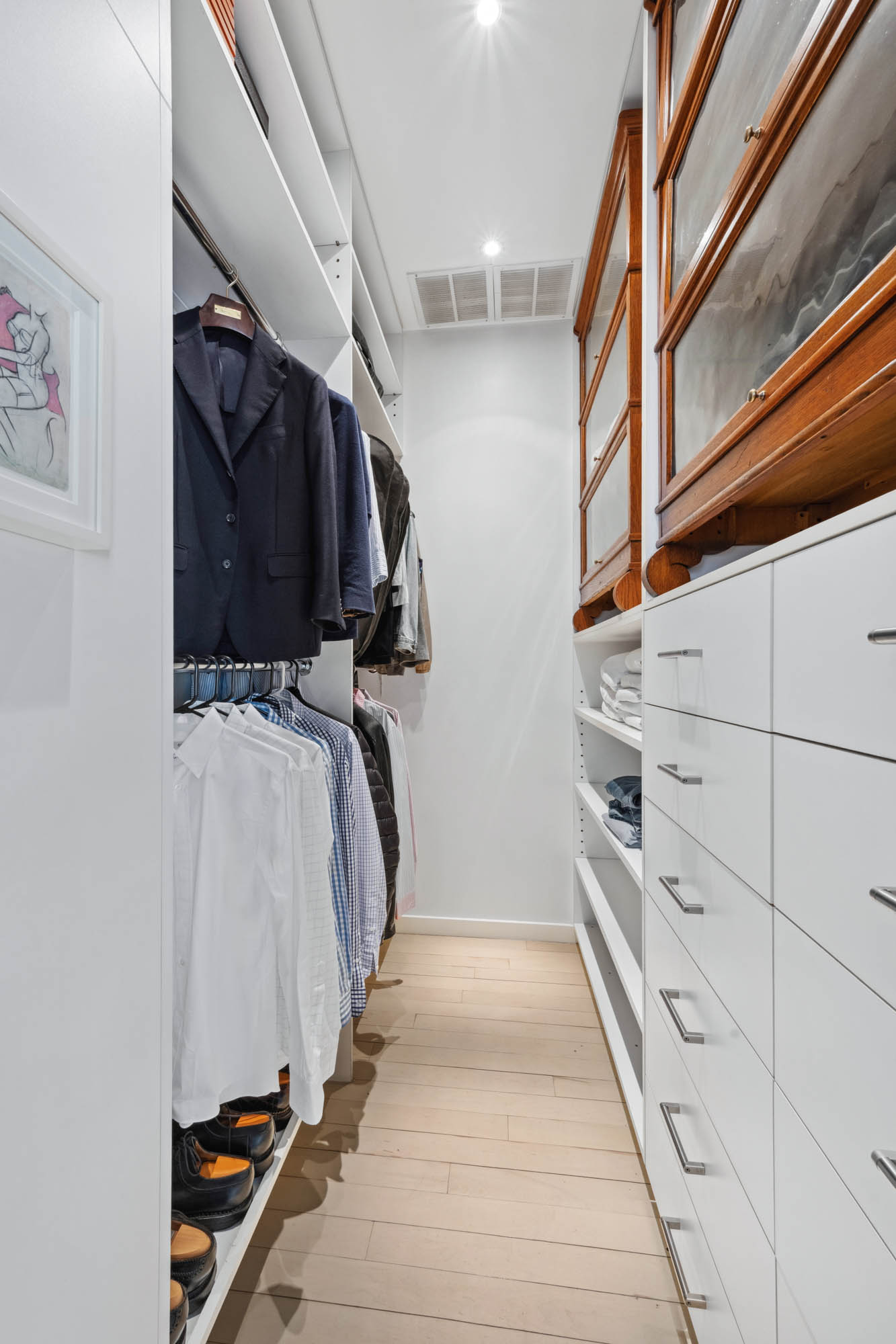 7 East 20th Street, Unit 6R Manhattan, NY 10003 - Photo 8 of 14 a view of walk in closet with clothes and shoes
