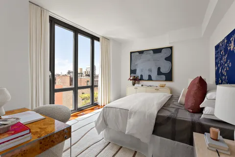 a bedroom with a bed and glass windows