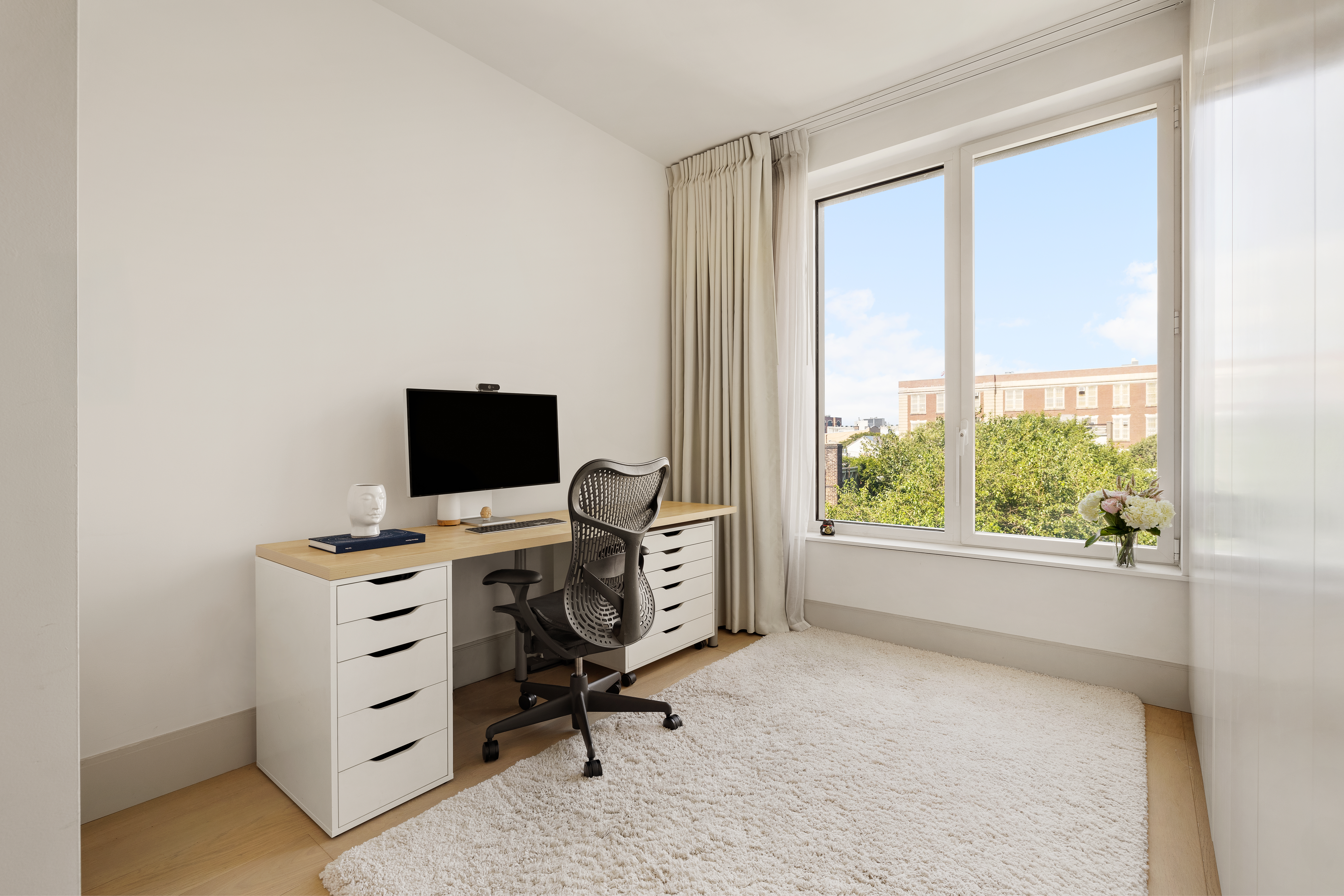 308 North 7th Street, Unit 5A Brooklyn, NY 11211 - Photo 9 of 12 a view of a workspace with furniture and a window
