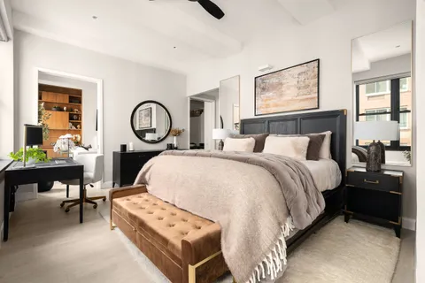 a bedroom with a bed and a chandelier