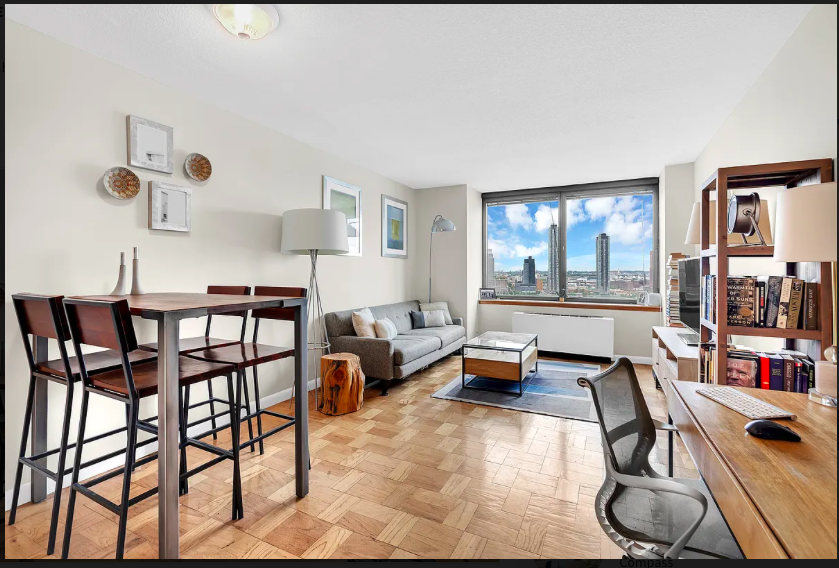 415 East 37th Street, Unit 22B Manhattan, NY 10016 - Photo 1 of 6 a living room with furniture and a large window