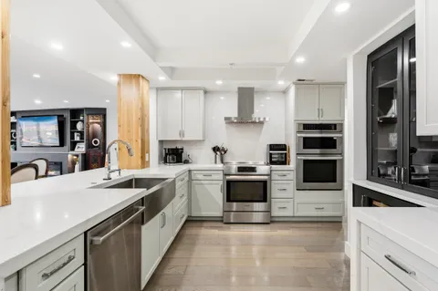 a kitchen with stainless steel appliances granite countertop a sink stove oven and refrigerator