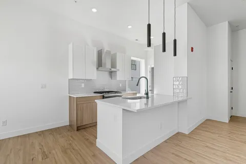a view of a kitchen with wooden floor