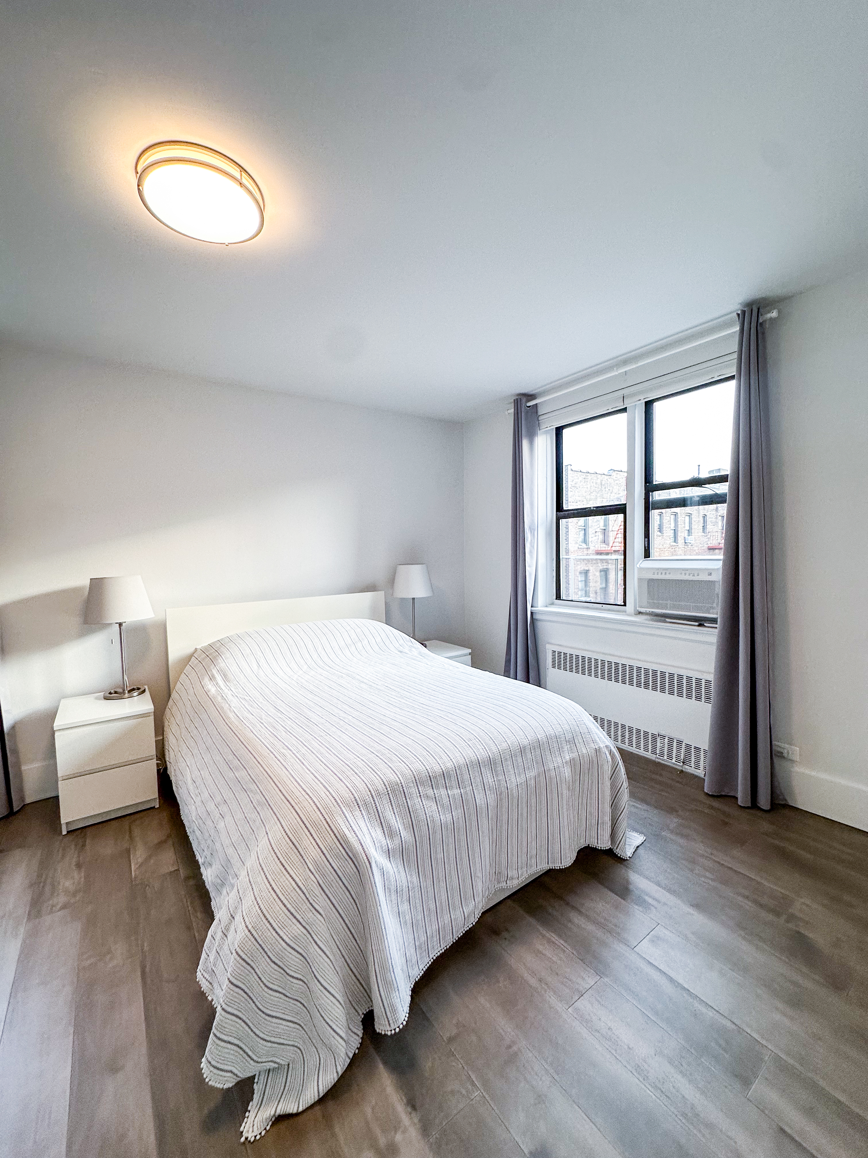 2420 Morris Avenue, Unit 6B Bronx, NY 10468 - Photo 10 of 16 a bedroom with a bed and a window