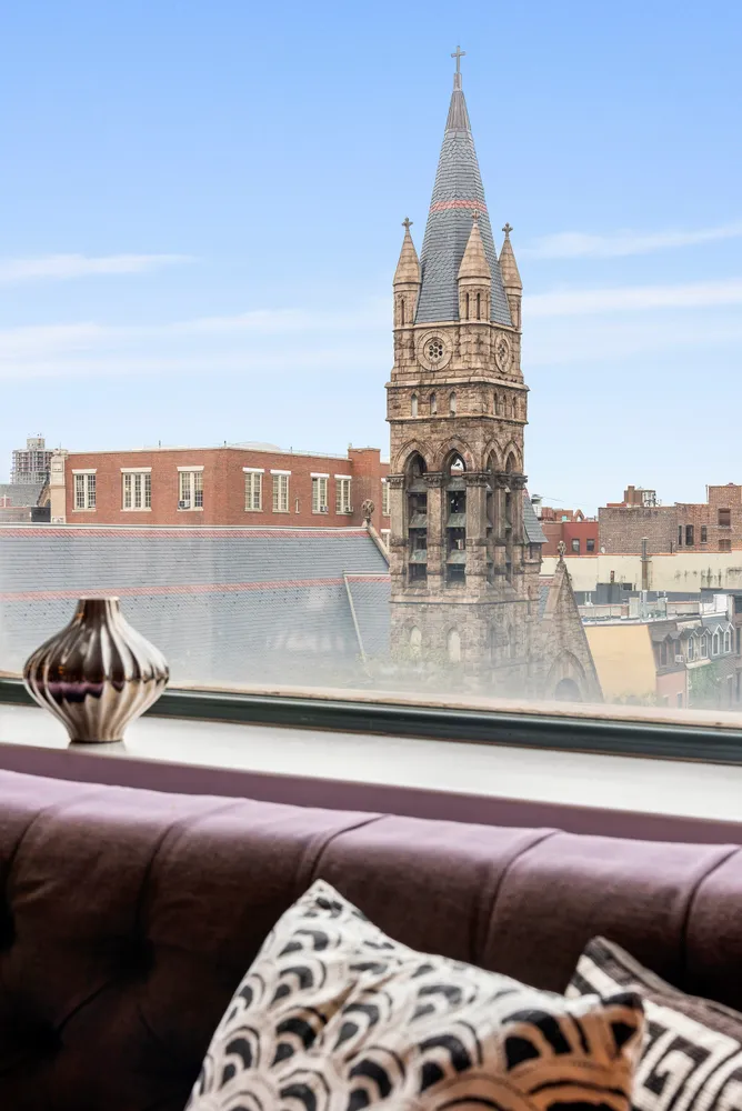 a theatre with furniture and floor to ceiling windows