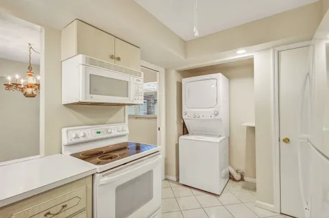 a kitchen with a stove cabinets and a refrigerator