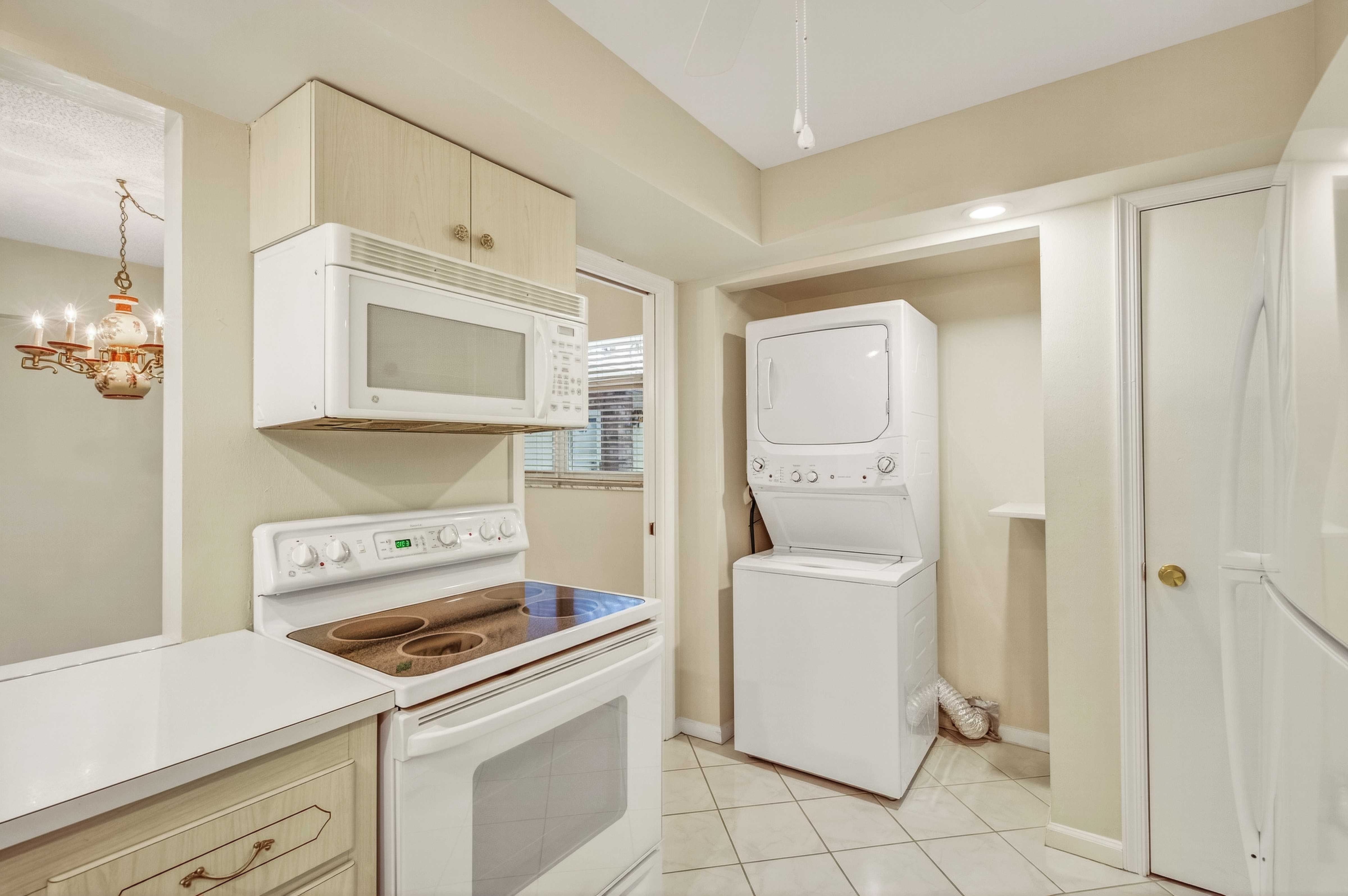 4601 Highway A1a, Unit 102 Vero Beach, FL 32963 - Photo 10 of 29 a kitchen with a stove cabinets and a refrigerator