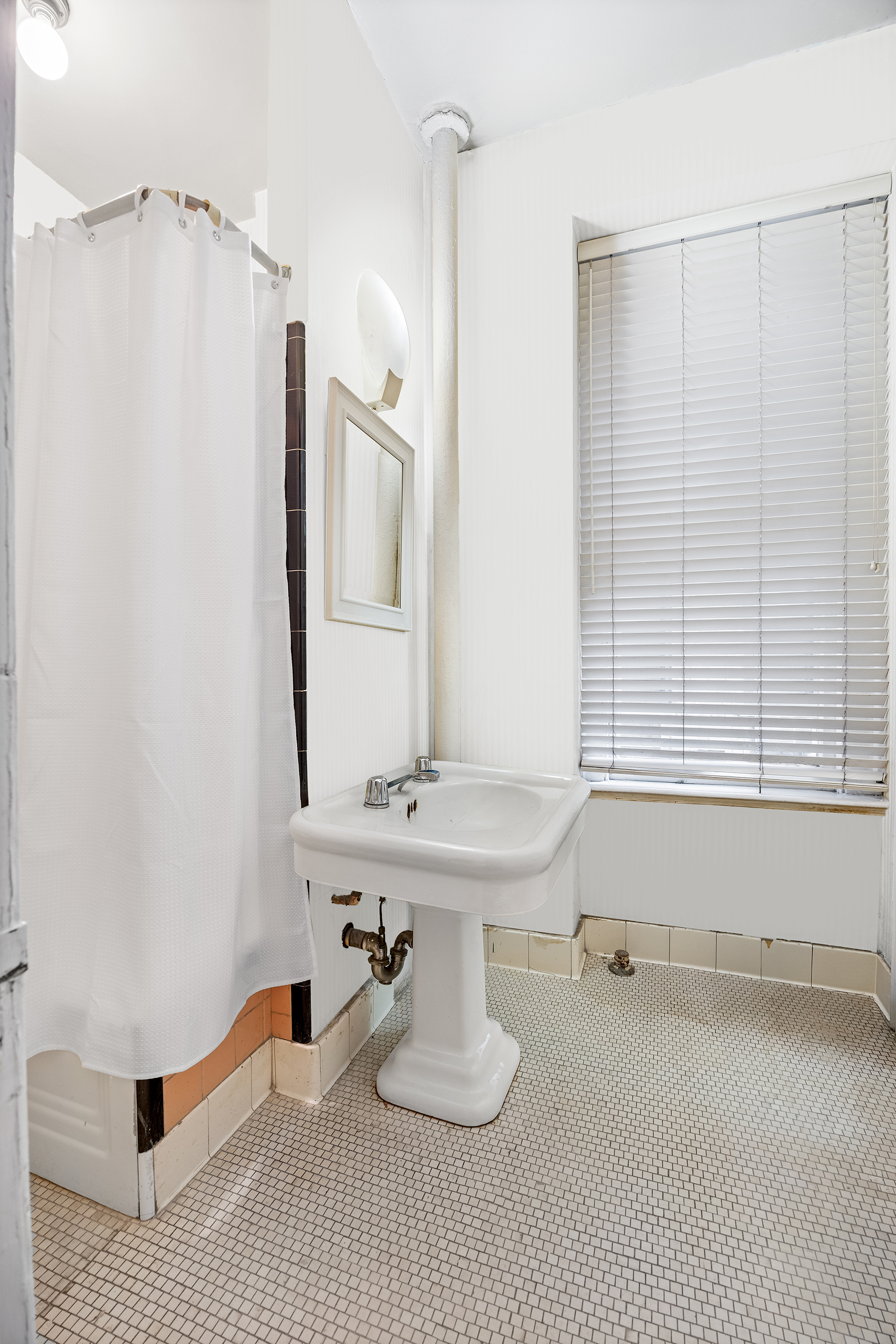525 Park Avenue, Unit 3D Manhattan, NY 10065 - Photo 7 of 9 a bathroom with a sink and a mirror