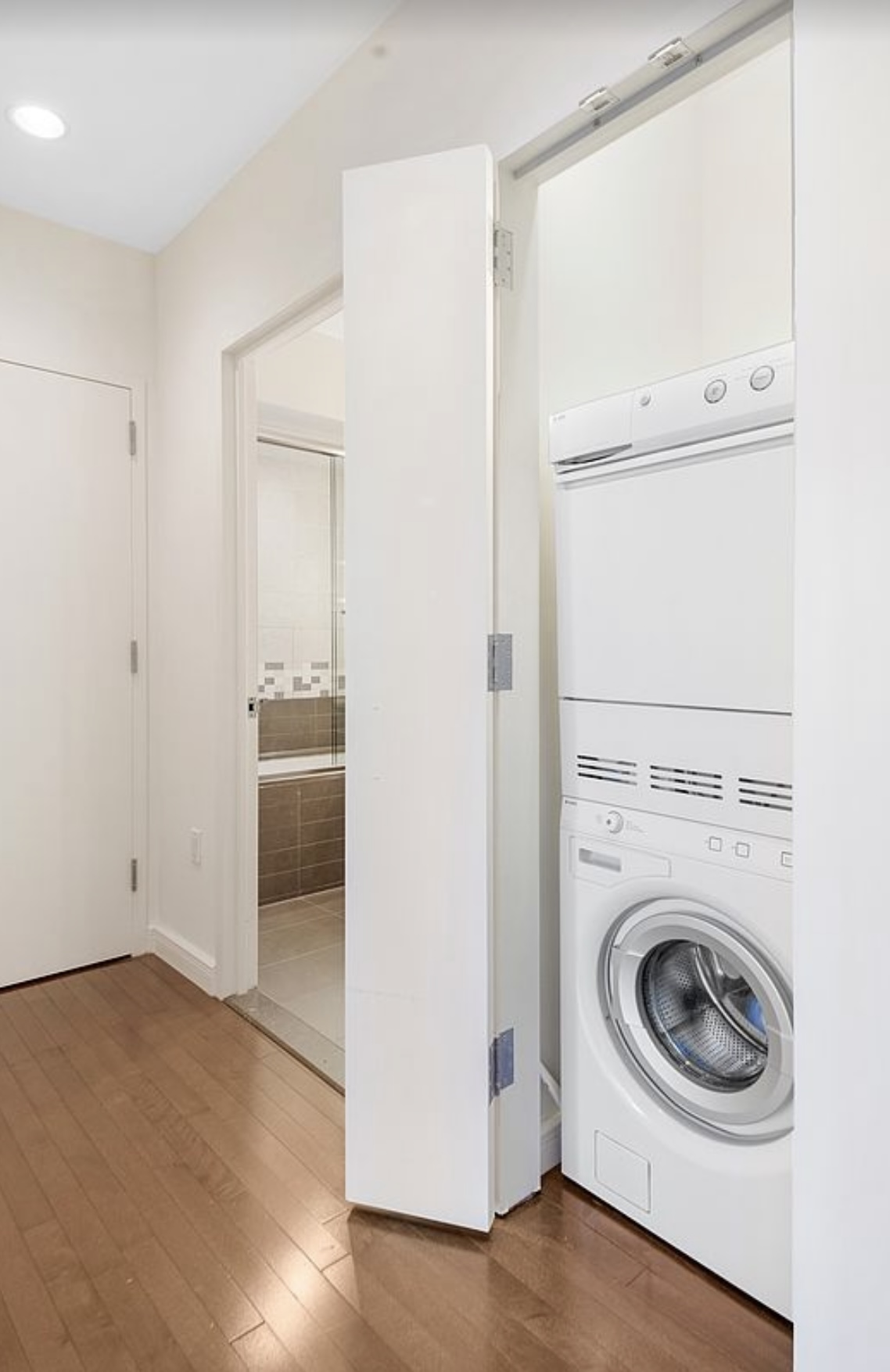 101 West 24th Street, Unit 7A Manhattan, NY 10011 - Photo 10 of 13 a utility room with dryer and washer