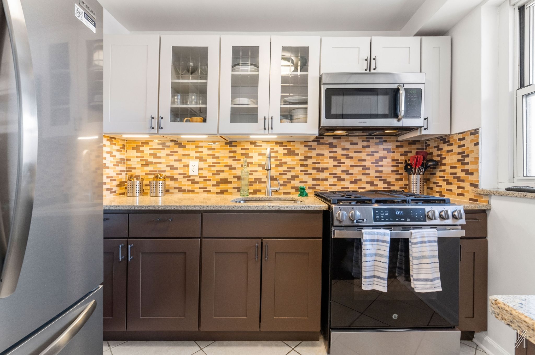 35-50 85th Street, Unit 7H Queens, NY 11372 - Photo 5 of 16 a kitchen with stainless steel appliances granite countertop a stove and a microwave