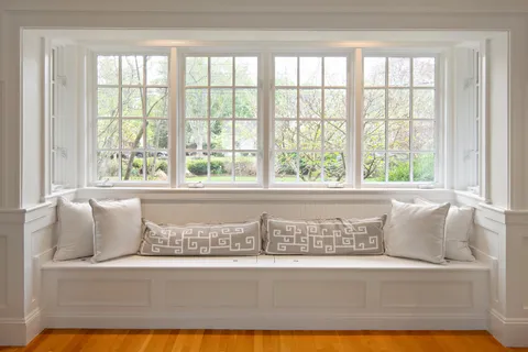 a white bath tub sitting next to a window