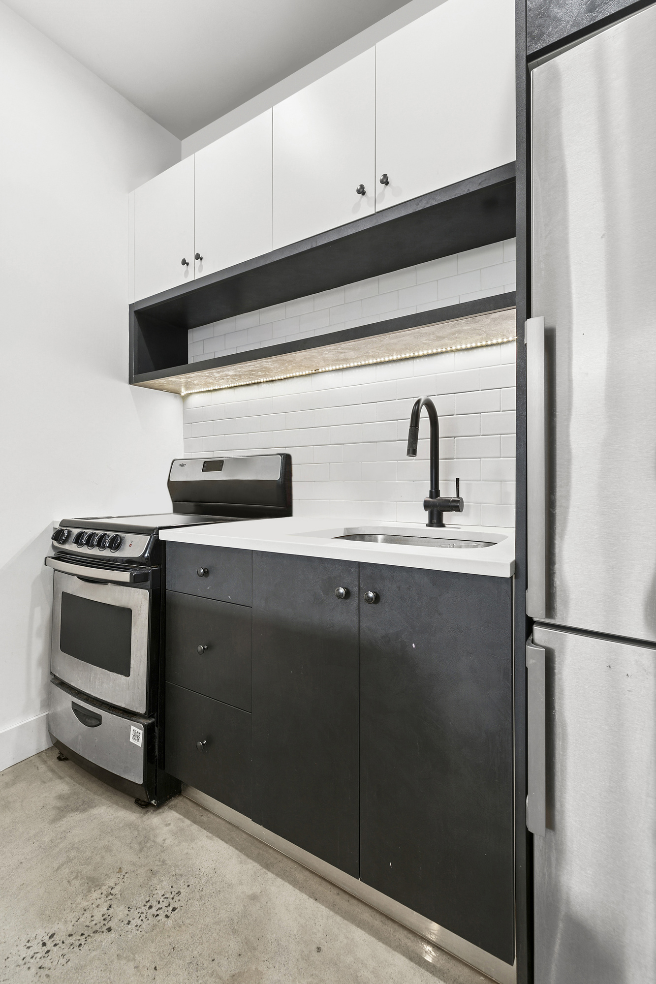 30 Belvidere Street, Unit 3A Brooklyn, NY 11206 - Photo 4 of 9 a kitchen with stainless steel appliances a refrigerator and a sink