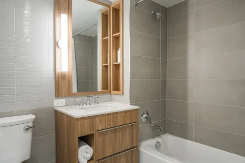 a bathroom with a sink a toilet and shower