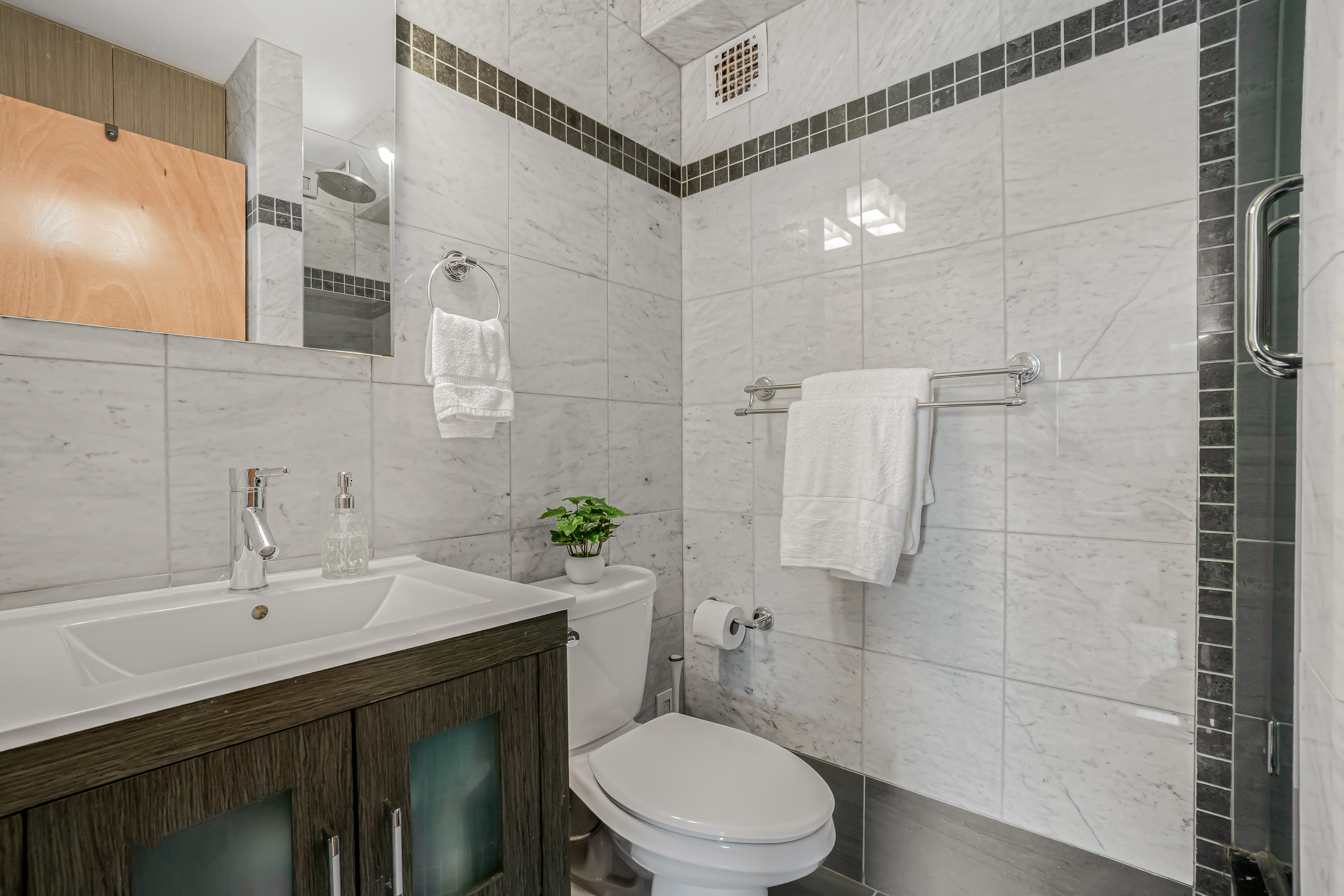 7 Gates Avenue, Unit H Brooklyn, NY 11238 - Photo 16 of 20 a bathroom with a sink a toilet and shower