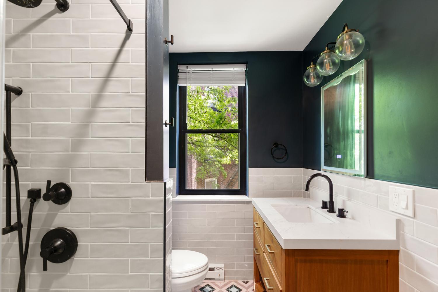 56 Prince Street Boston, MA 02113 - Photo 6 of 8 a bathroom with a sink a toilet and a mirror