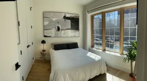 a bedroom with a bed and a window