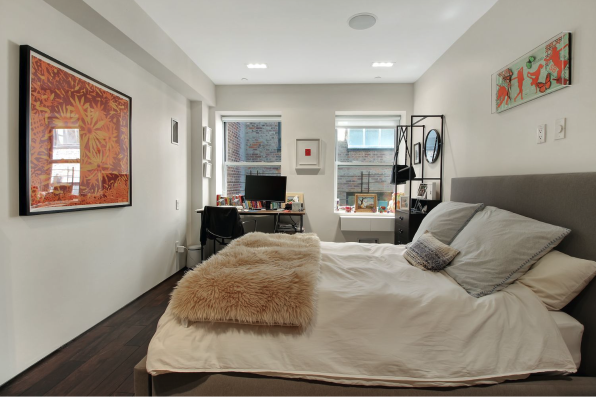 405 Broadway, Unit 4 Manhattan, NY 10013 - Photo 13 of 19 a bedroom with a bed and wooden floor