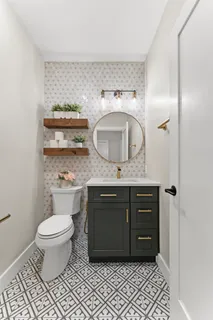 a bathroom with a toilet a sink and mirror