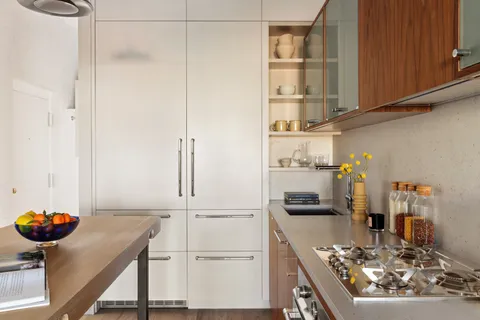 a kitchen with a refrigerator and a stove