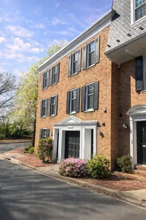 front view of a brick house with a yard