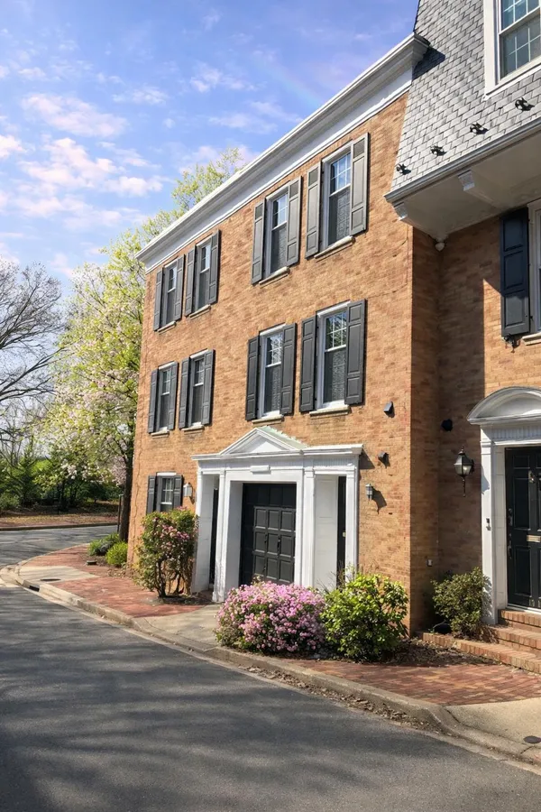 front view of a brick house with a yard