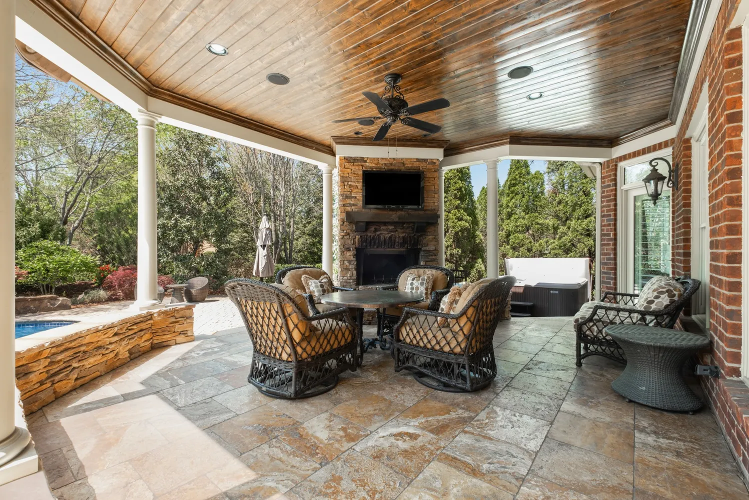 a outdoor living space with furniture potted plant and a large window