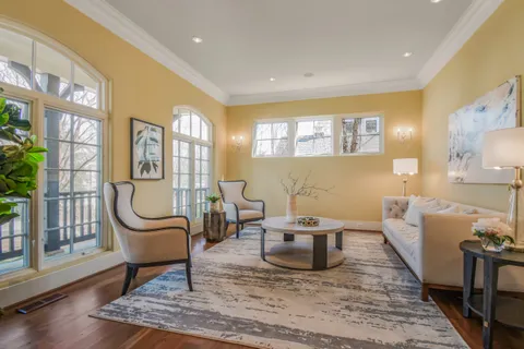 a living room with furniture a rug and a lamp
