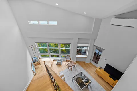 a view of a workspace with furniture and a window