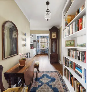 a living room with fireplace furniture and a book shelf