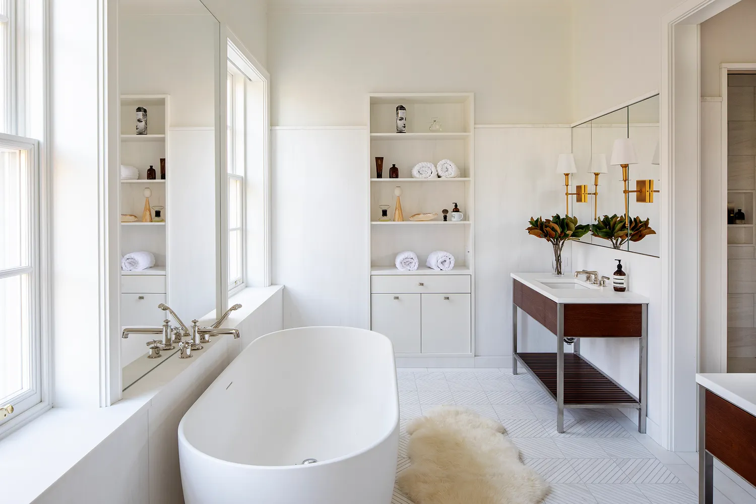 a spacious bathroom with a double vanity sink a mirror and a bathtub