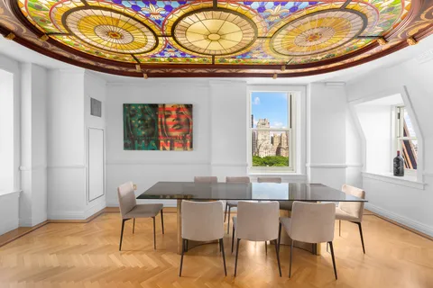 a view of a dining room with furniture and chandelier