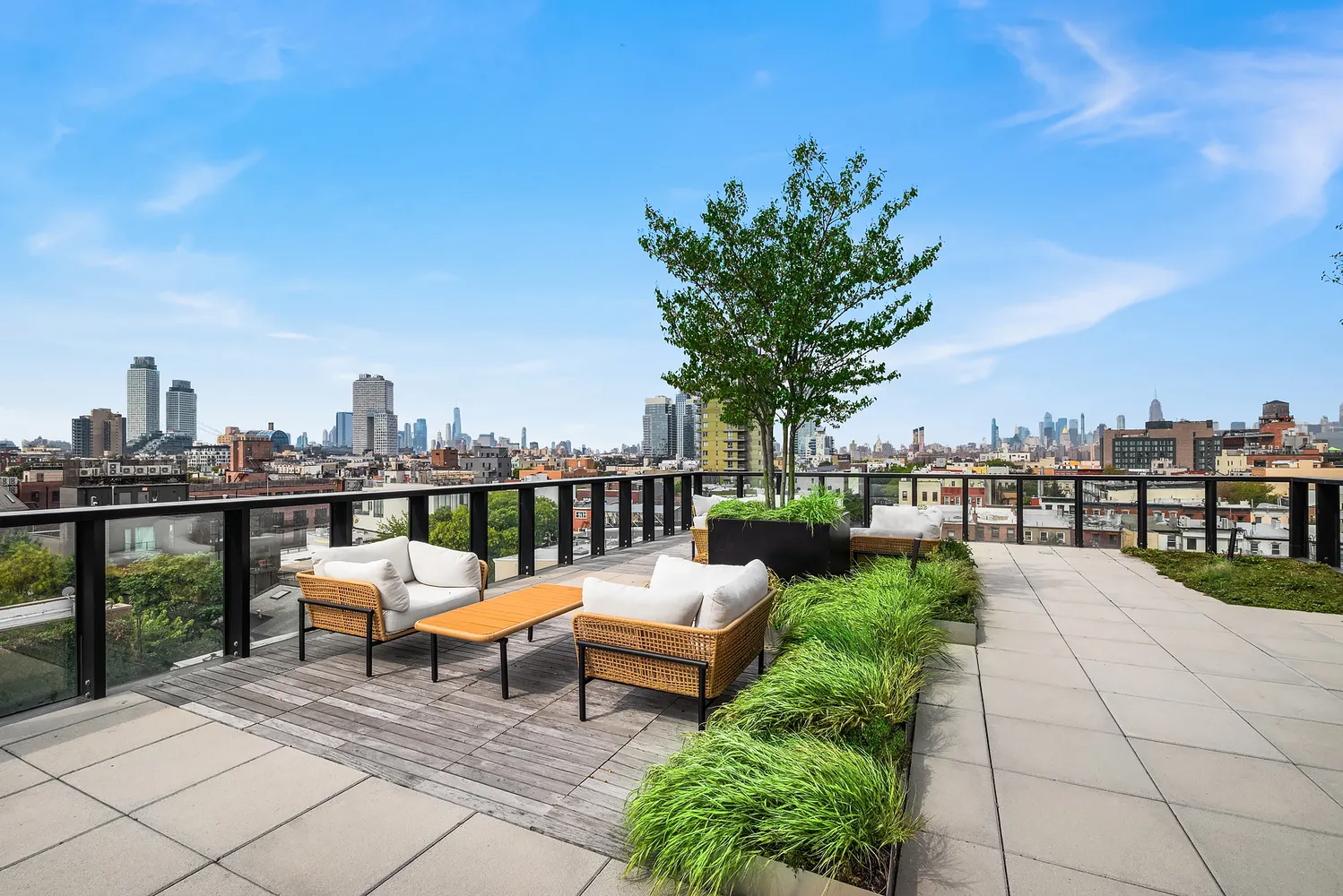 a view of a terrace with lawn chairs and iron fence