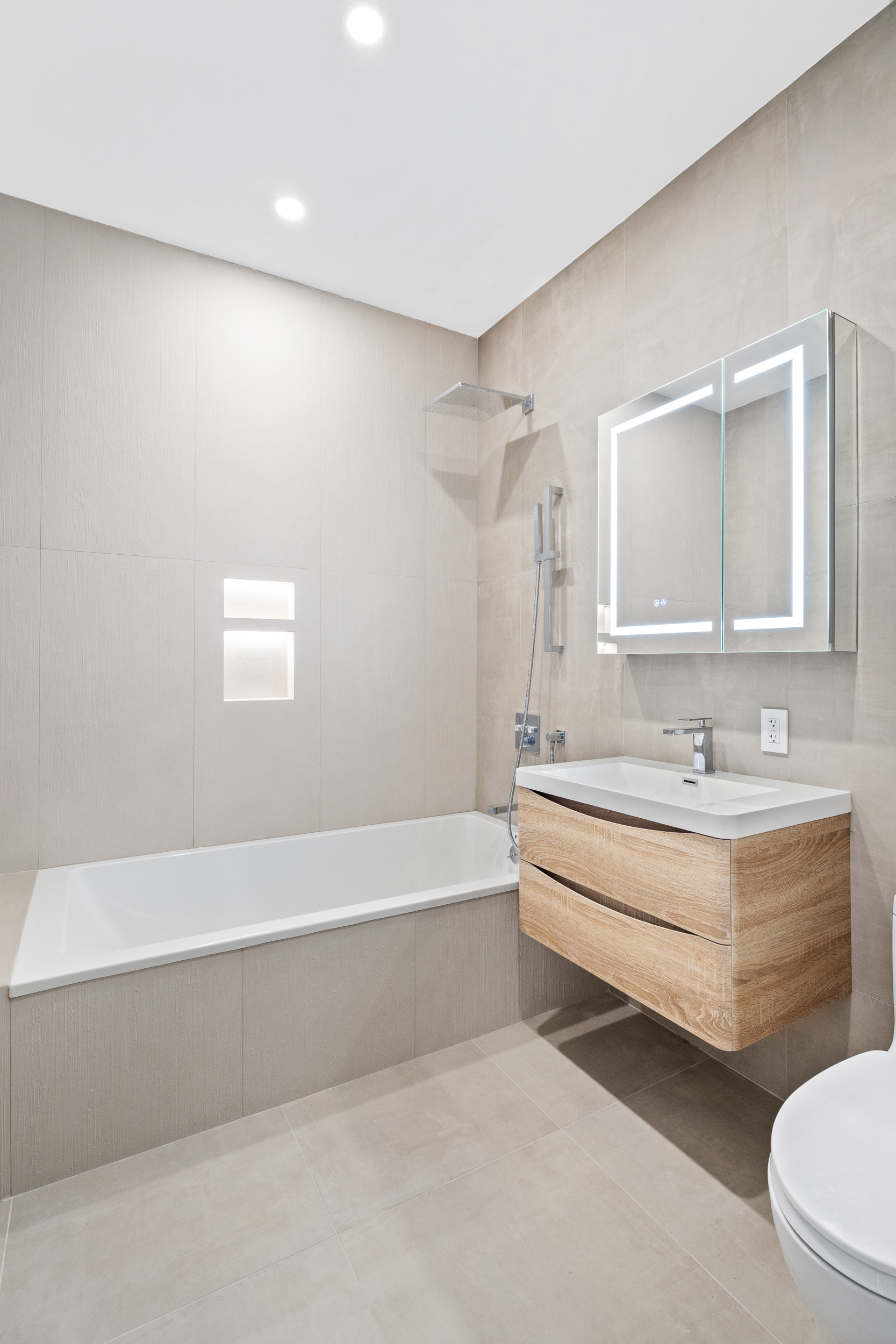 249 18th Street, Unit 1 Brooklyn, NY 11215 - Photo 9 of 12 a bathroom with a bathtub a sink and a toilet