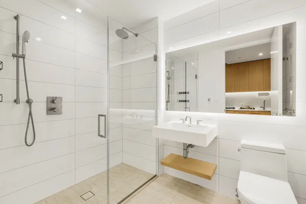 a bathroom with a sink toilet a mirror and shower