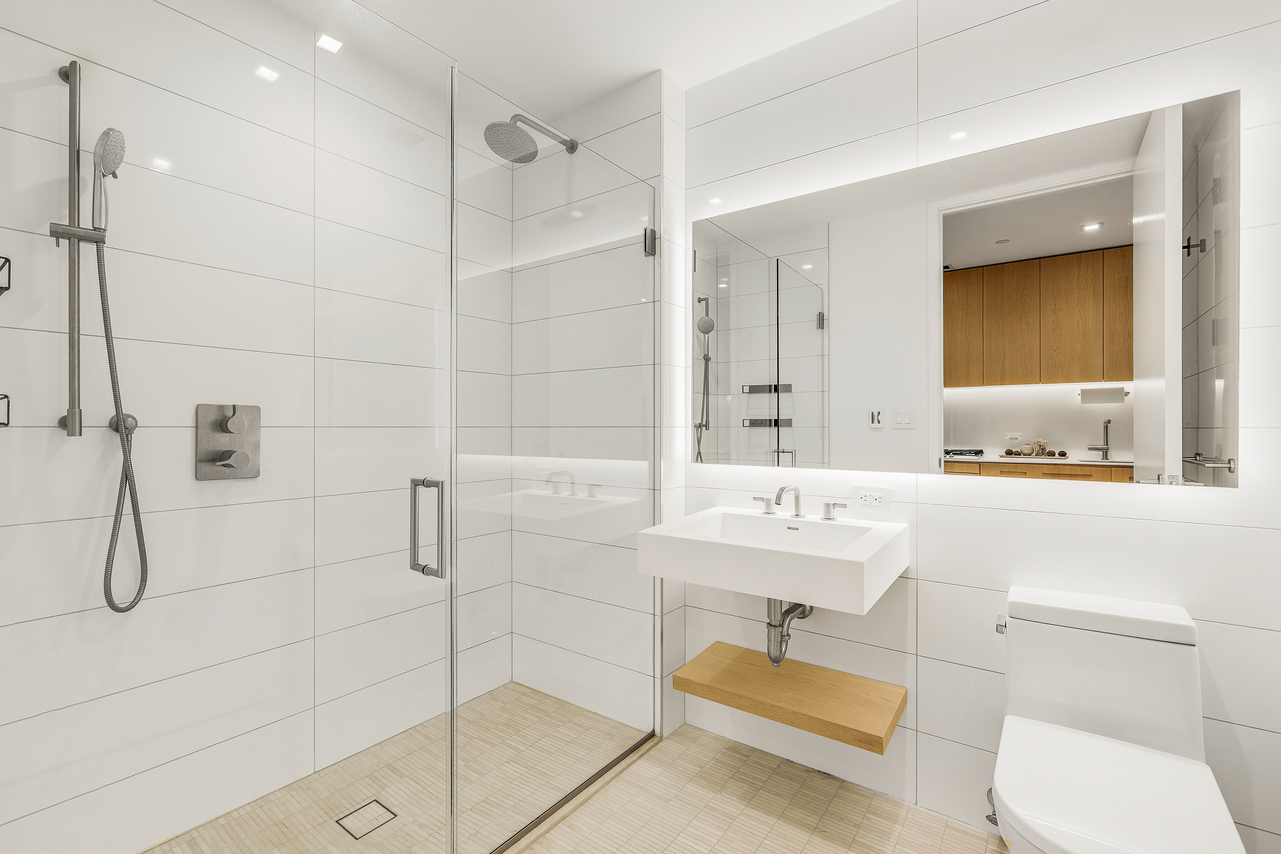 98 Front Street, Unit 9A Brooklyn, NY 11201 - Photo 10 of 31 a bathroom with a sink toilet a mirror and shower