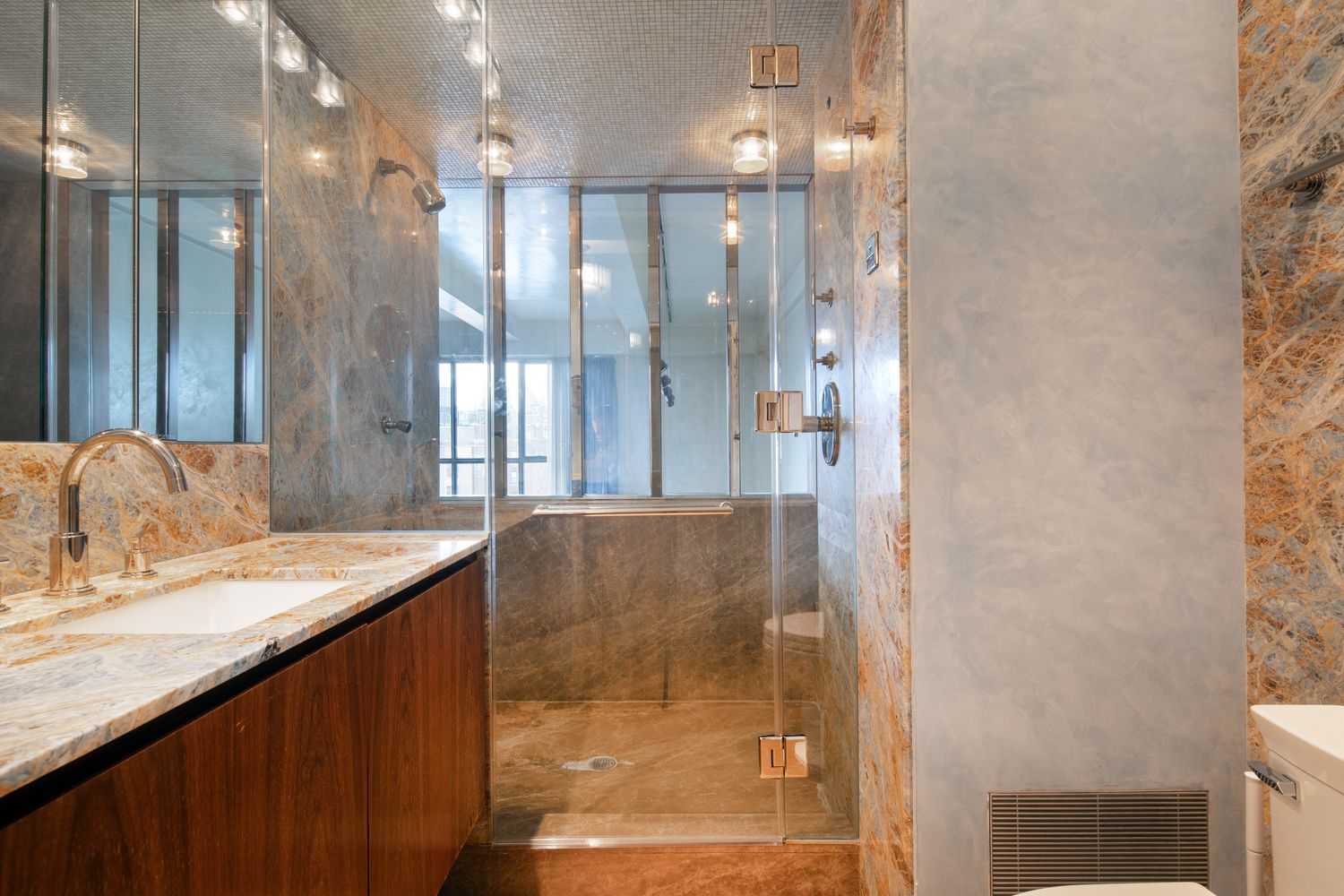 a bathroom with a granite countertop sink a shower and a mirror