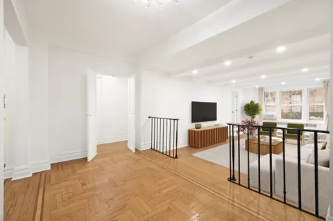 a view of a living room kitchen and a wooden floor