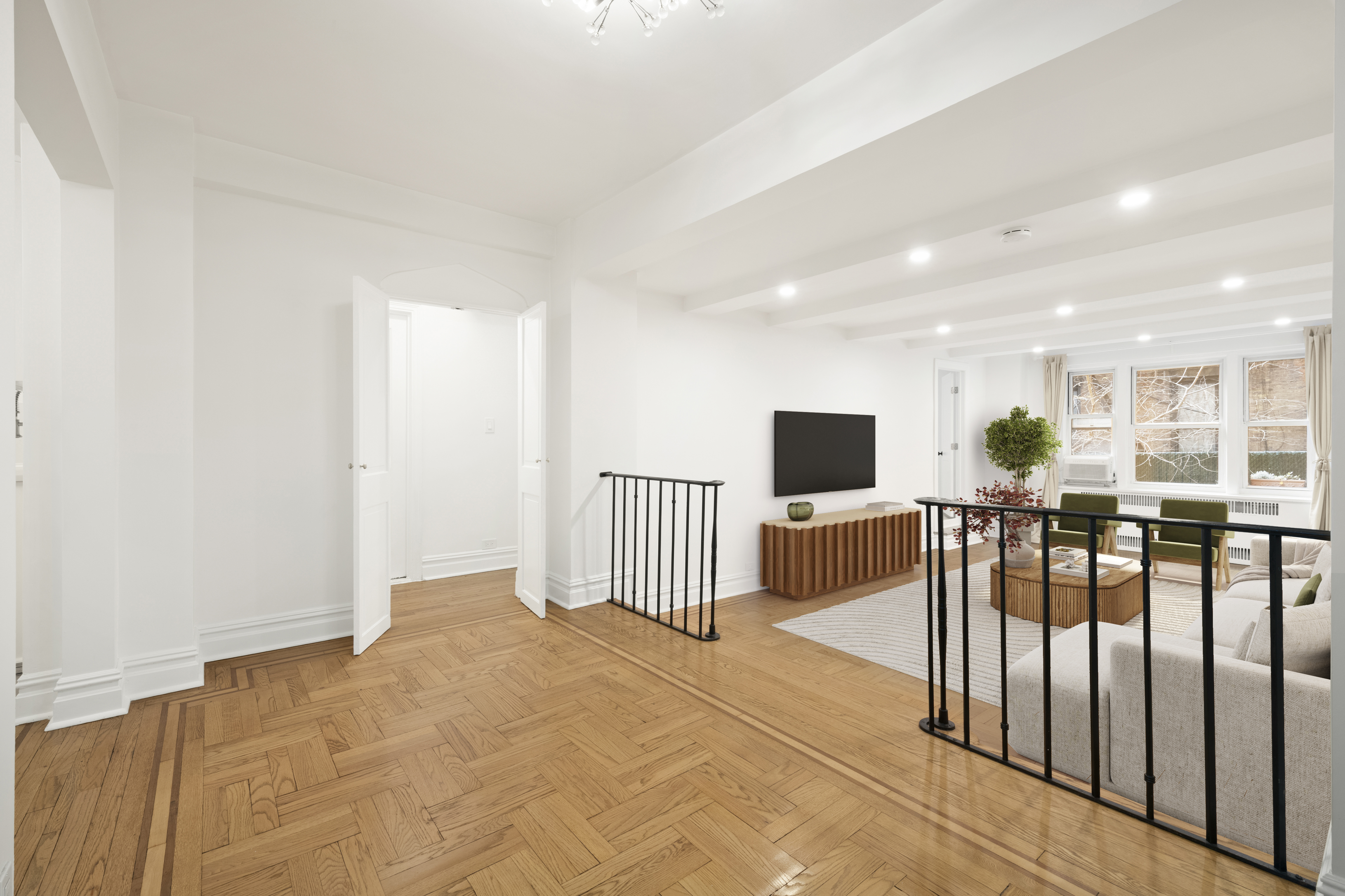 a view of a living room kitchen and a wooden floor